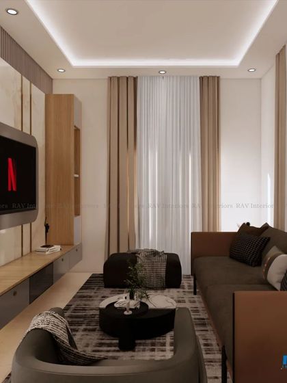 A view of a cozy family room or den, showing the TV unit and comfortable seating. The neutral color palette creates a relaxing atmosphere.