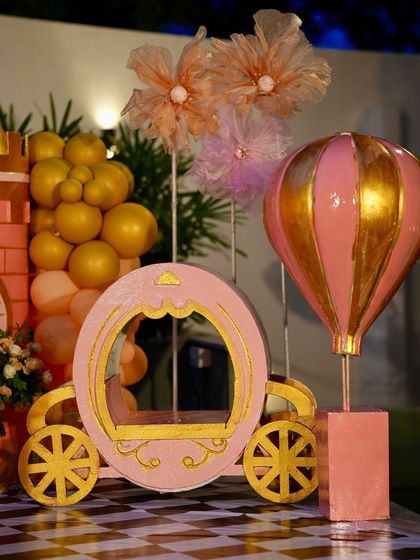 A beautiful pink and gold princess carriage prop, adding a touch of royal elegance to the party decor.