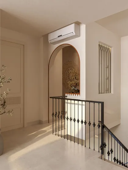 This view from the staircase landing shows how the puja room is integrated into the home's architecture, visible through its arched opening.
