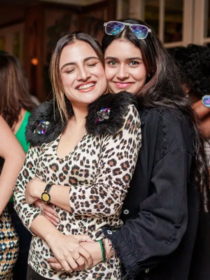 Friends hugging and enjoying the feel-good vibes of the party.