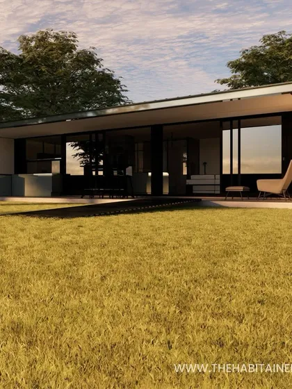 An exterior view of the dual-container studio, showing its sleek, modern design in a grassy field.