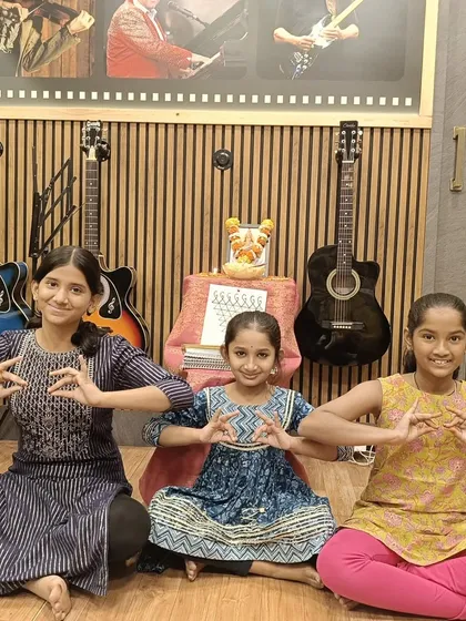 Our young students celebrating Saraswati Pooja at the academy. We believe in nurturing a deep cultural understanding alongside artistic training, creating a holistic learning experience.