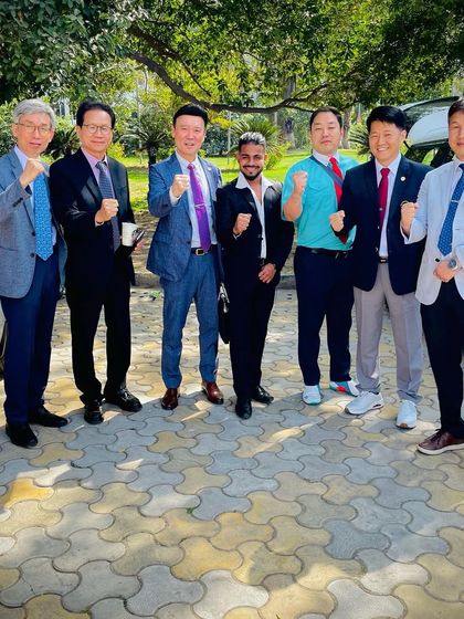 A moment of unity with the Korean Masters, all in a fighting pose. Taekwondo connects us all.