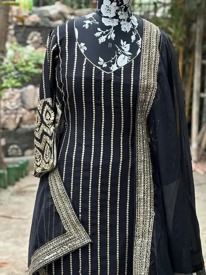The kurta features beautiful handwork on the sleeves and border, while the sharara pants have vertical lines of gotta patti.