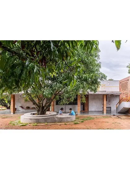 At the 'Aamra' farmhouse, life unfolds around a mature mango tree, which serves as the heart of the home. The design prioritizes the existing landscape, creating a built form that respects and integrates with the natural environment, offering spaces for quiet contemplation and family life.