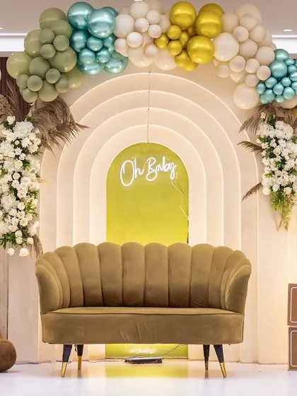 The main stage for Twinkle's baby shower, featuring a modern arch backdrop and a chic 'Oh Baby' neon sign. The design is softened with teddy bears and a beautiful organic balloon garland.