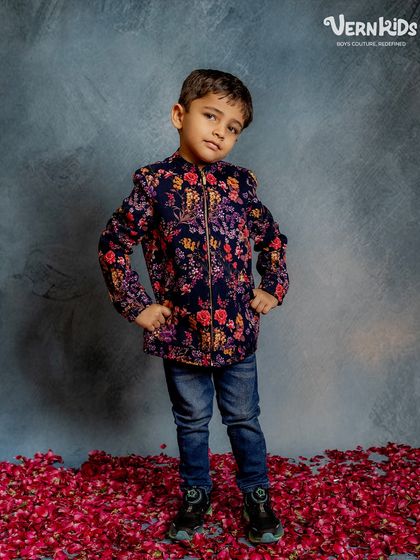 Full-length view of the floral bomber jacket, showing how it pairs perfectly with jeans for a smart yet relaxed look.