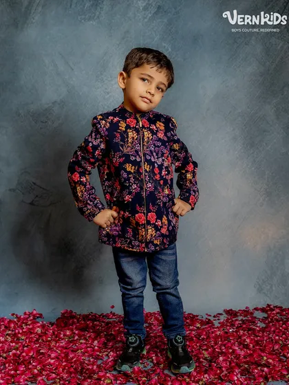 Full-length view of the floral bomber jacket, showing how it pairs perfectly with jeans for a smart yet relaxed look.