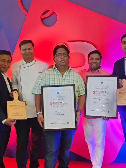 The team proudly displaying the certificates and awards.