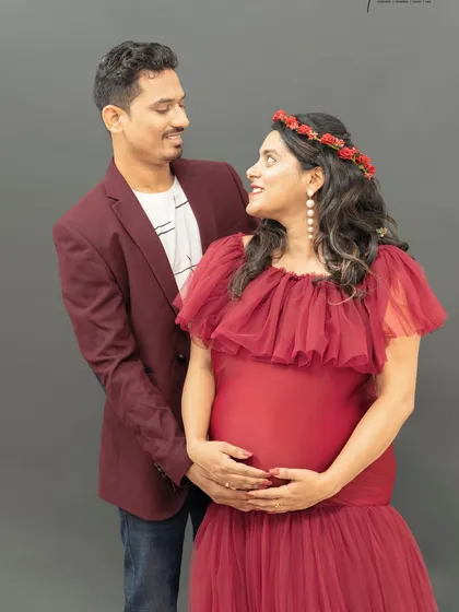 The look of love. This candid moment captures the couple gazing at each other, lost in their own little world. The floral crown adds a soft, bohemian touch to the mom to be's look.