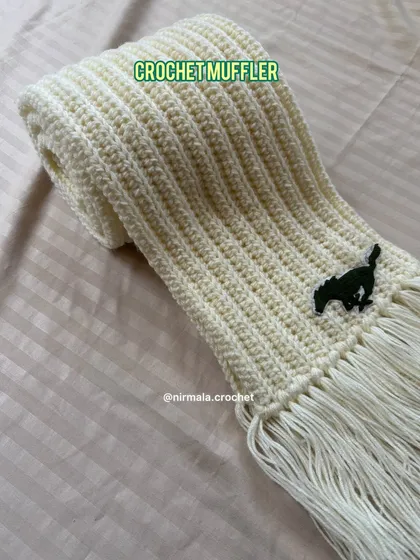 Another angle of the personalized cream muffler, showing the texture of the ribbed stitch and the custom logo.
