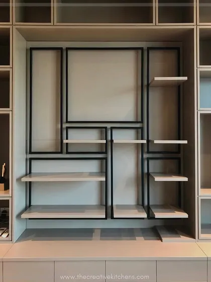 A detailed view of the library's central feature. We integrated a geometric metal frame with floating shelves, creating a dynamic display area that breaks the uniformity and adds a layer of industrial-chic design.