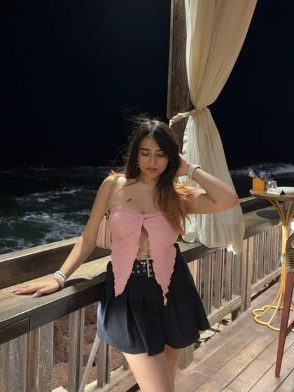 A peaceful moment on a balcony overlooking the ocean at night. This shot is serene and romantic.