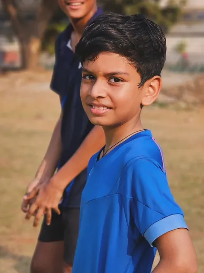 A young player smiles during a break at our summer camp, showing that hard work can also be fun.