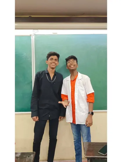 Two students in their Bollywood-inspired costumes, one as a doctor, ready for a fun day.