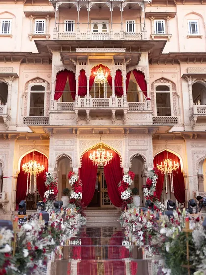 The majestic facade of Chomu Palace, transformed for a regal wedding night. Our expertise in large-scale events allows us to enhance the inherent grandeur of heritage venues with opulent floral arrangements, dramatic draping, and magnificent lighting.