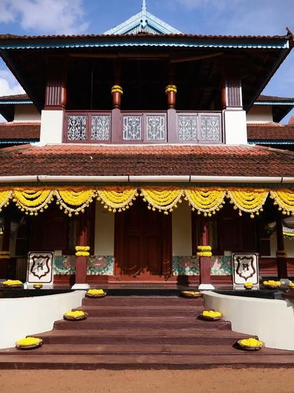 Accessorizing a 75-year-old heritage home in God's Own Country. Simple, elegant marigold garlands adorn the facade, enhancing the traditional Kerala architecture without overpowering it.
