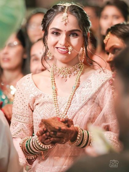 A close-up of the bride's happy face during the rituals. The minimal makeup ensures she looks like the best version of herself.