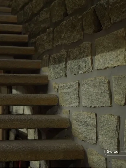 A close-up of the stone staircase, showing the texture and durability of the natural material used for high-traffic areas.