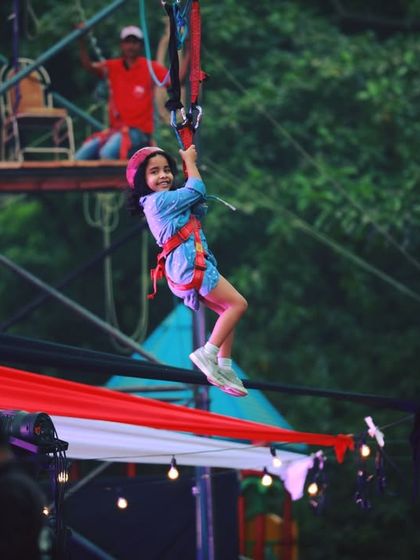 Soaring through the air on a zip line! This is the ultimate adventure activity for a large outdoor event, providing a safe but exhilarating experience for kids.