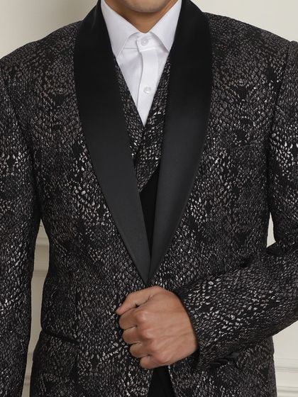 A close-up of a black and silver patterned tuxedo jacket, perfect for a cocktail or reception. The texture is everything.