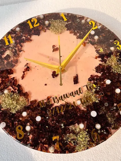 This clock was made from a 1.5-year-old garland. The dark, rich colors of the aged petals create a beautiful, rustic look against the peach-colored resin.
