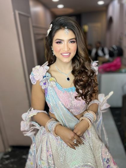My gorgeous engagement bride in a unique pastel lehenga. The makeup has hints of pink and purple to match the beautiful floral details on her outfit.