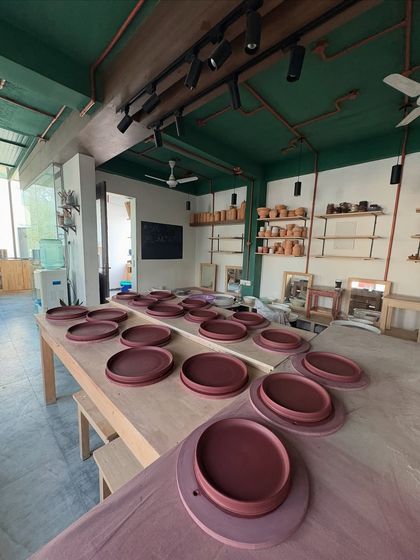 The studio table filled with dinner plates from the Lagavi collection. Seeing hundreds of uniform pieces ready to go is both daunting and incredibly satisfying.