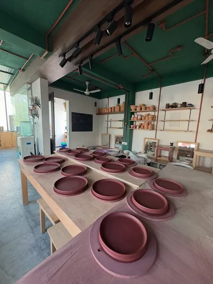 The studio table filled with dinner plates from the Lagavi collection. Seeing hundreds of uniform pieces ready to go is both daunting and incredibly satisfying.