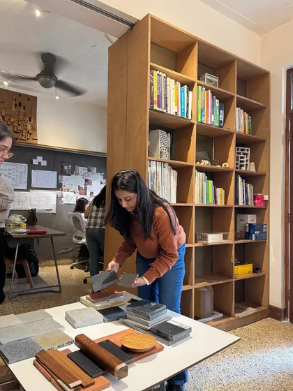 A team member organizing material samples in our studio. The space is designed to be a hands-on library, with our extensive collection of books and materials always within reach for inspiration and client meetings.