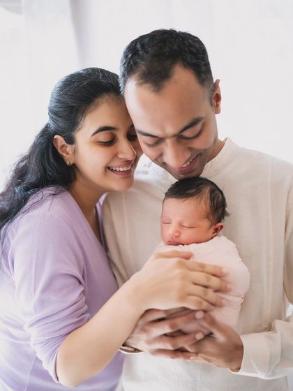 A beautiful family portrait with a newborn, capturing the love and happiness of the new parents.