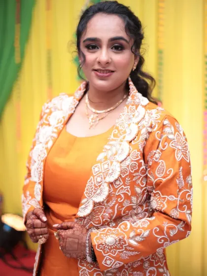 Another angle of the Mayera look, showing the intricate white embroidery on her jacket. The makeup is soft and glowing, perfect for a daytime family function.