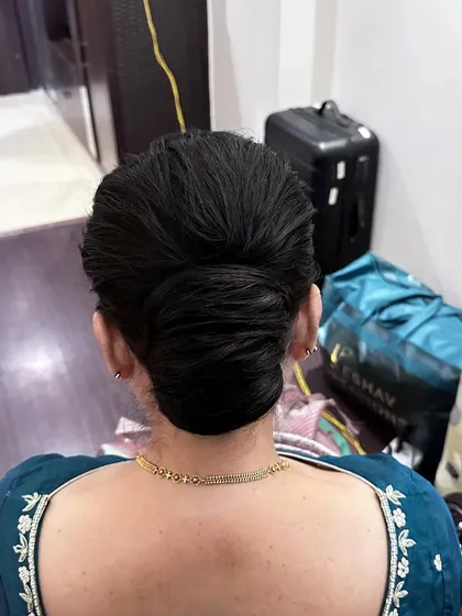 A textured French knot bun, offering a modern twist on a classic style. This look is perfect for a chic, minimalist bride or a wedding guest.