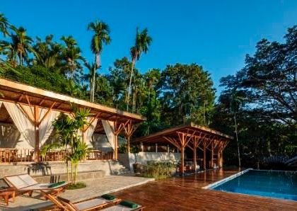 The main pool, restaurant, and bar pavilions are constructed with a light timber framework that sits gently in the landscape.