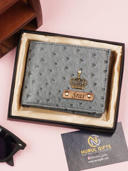 A new design in my collection, this grey wallet has a unique dotted texture and is personalized with a crown charm and nameplate.