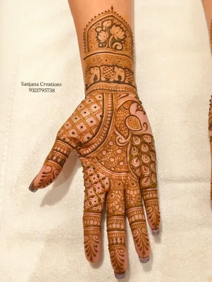 A close-up of the palm, where a graceful peacock is the star of the design.