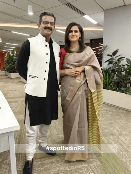 A customer looking elegant in our beige and yellow striped silk saree. Paired with a red blouse, it creates a classic, sophisticated look.
