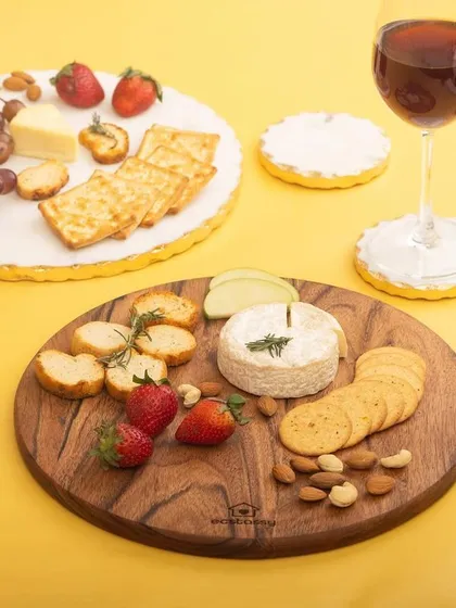 A colorful and bright shot of two different serving platters from Ecstasy, styled with cheese, crackers, and fruit. This shows the versatility of the product line.