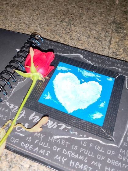 A page from my art journal featuring a small painting of a heart-shaped cloud against a blue sky, surrounded by handwritten thoughts.