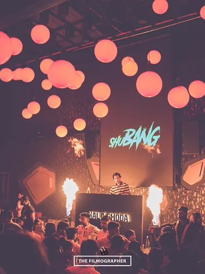 The scene at a packed club night, with the venue lit by red lanterns and my stage enhanced with fire projectors. I know how to create a unique atmosphere for any venue.