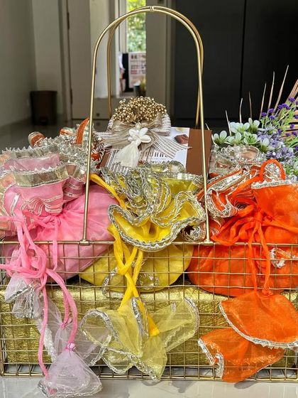 Another gift of love for Diwali. This basket is a riot of color, with vibrant gota potlis in shades of pink, yellow, and orange, making it a truly festive and joyful present.