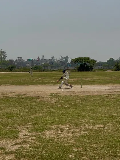 A batsman playing a powerful shot during the final.