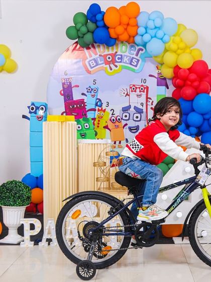 A magical 'Mermaid' themed birthday party, with shimmering blue and green decor, seashell props, and mermaid cutouts, creating an enchanting underwater world.