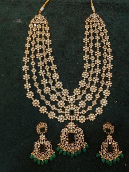 A beautiful layered haram with matching earrings. This designer piece is made with high-quality stones and is perfect for a glamorous party look.