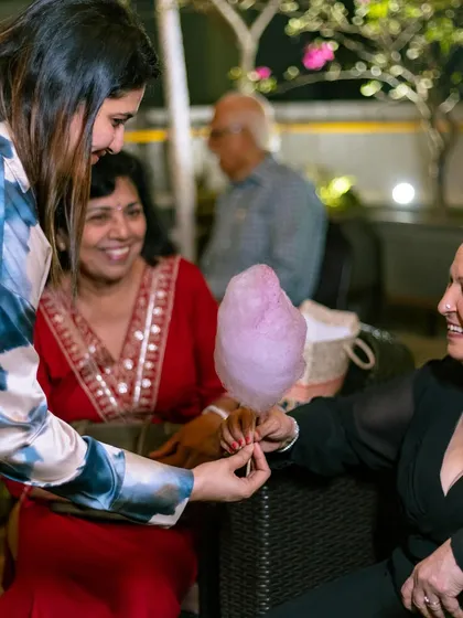 A moment of sweetness shared between guests. We love seeing our cotton candy bring people together at celebrations like this 70th birthday party.