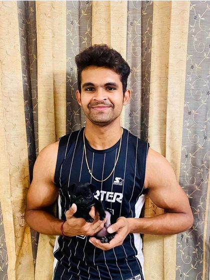 This proud new owner is with his tiny black Pug puppy. Even our smallest pups are guaranteed to be healthy, active, and full of character.