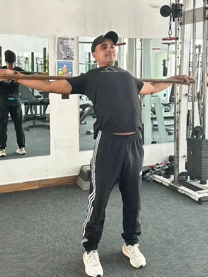 A backbend stretch using a stick for support. This helps to open up the chest and improve spinal flexibility.