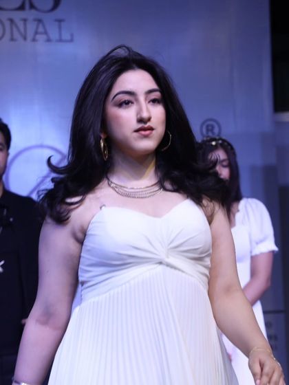 A model walking the runway at the Beautech Expo, her hair styled in beautiful, bouncy waves.