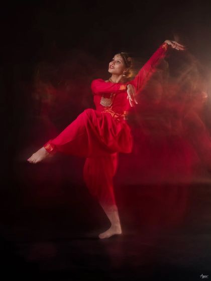 Here we used a slow shutter speed to paint with light and motion. The result is a fiery, abstract image where the dancer's form is sharp amidst a blur of movement, creating a truly poetic frame.