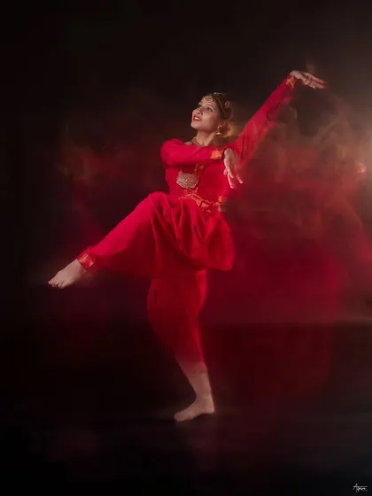 Here we used a slow shutter speed to paint with light and motion. The result is a fiery, abstract image where the dancer's form is sharp amidst a blur of movement, creating a truly poetic frame.